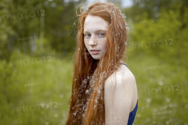 Caucasian girl with dandelion seeds hair
