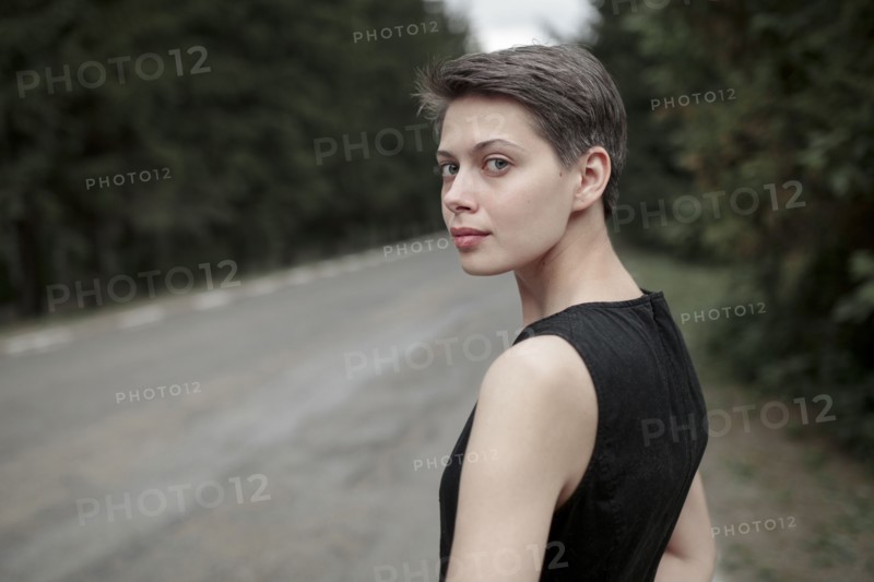 Caucasian woman standing near road