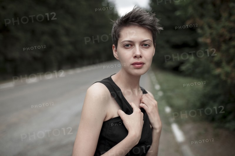 Serious Caucasian woman standing in road