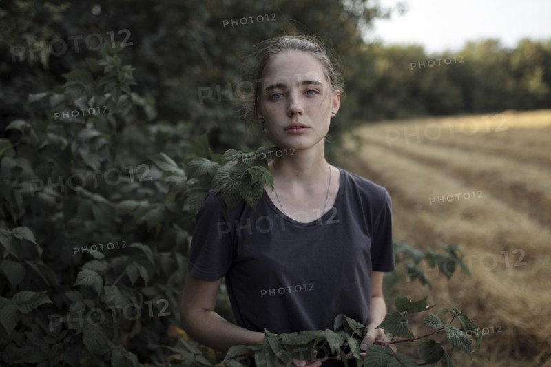 Portrait of Caucasian teenage girl holding branch