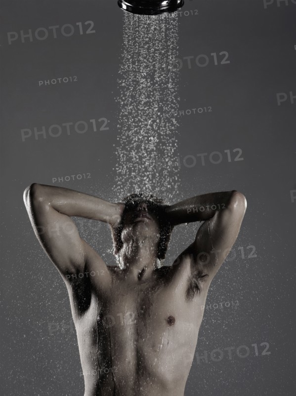 Caucasian man standing in shower