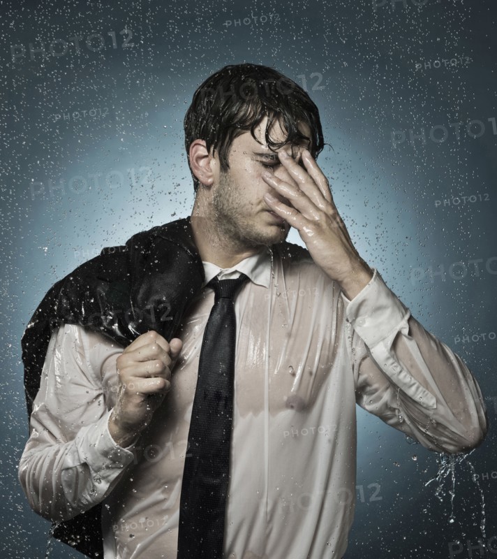 Caucasian businessman standing in the rain