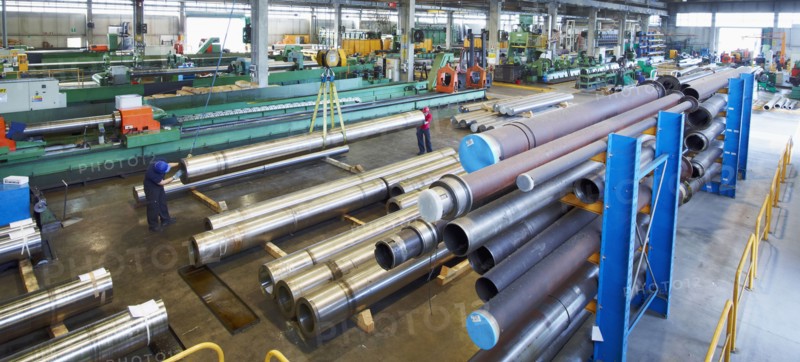 Workers and piping in factory