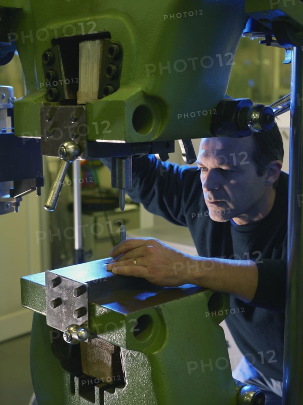 Caucasian worker using industrial drill