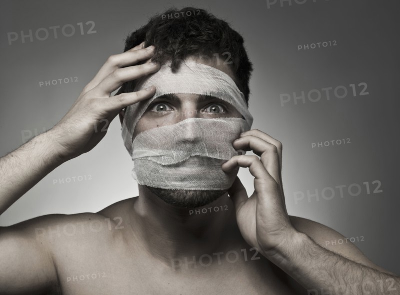 Man with bandages on his face