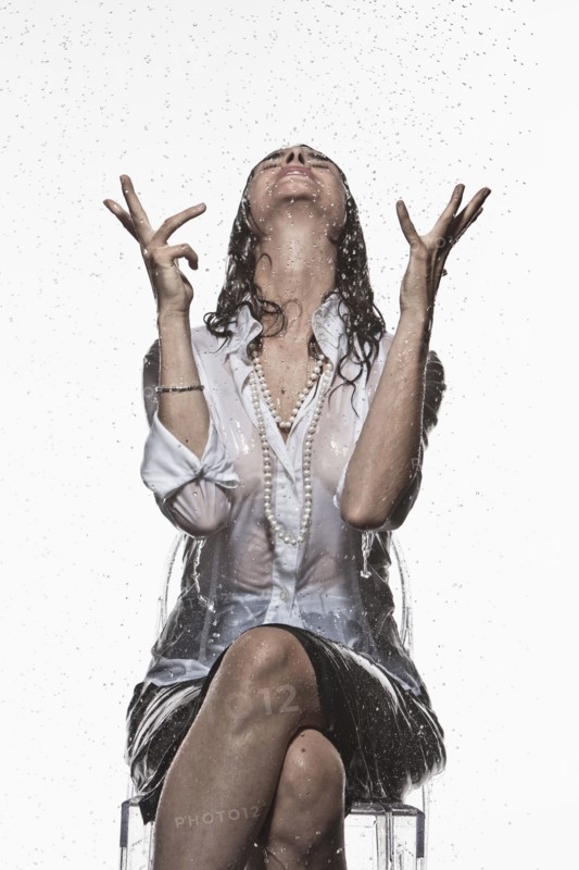 Rain falling on Caucasian businesswoman
