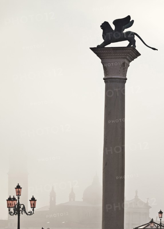 Silhouette of statue on pillar