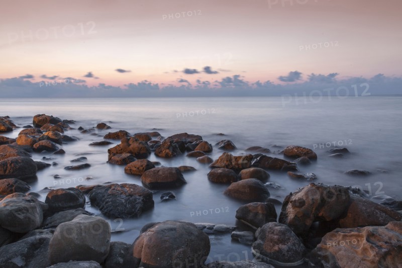 Blurred ocean washing over rocks