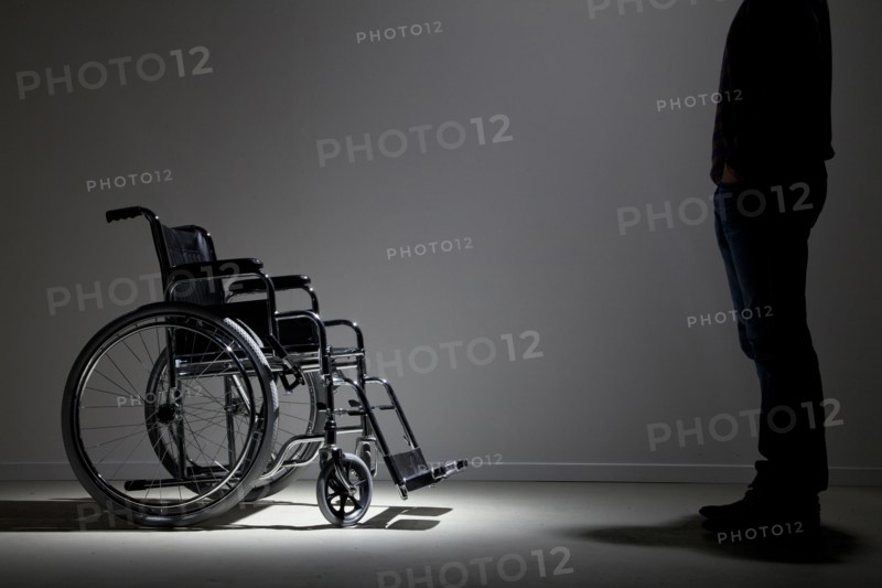 Caucasian man approaching wheelchair