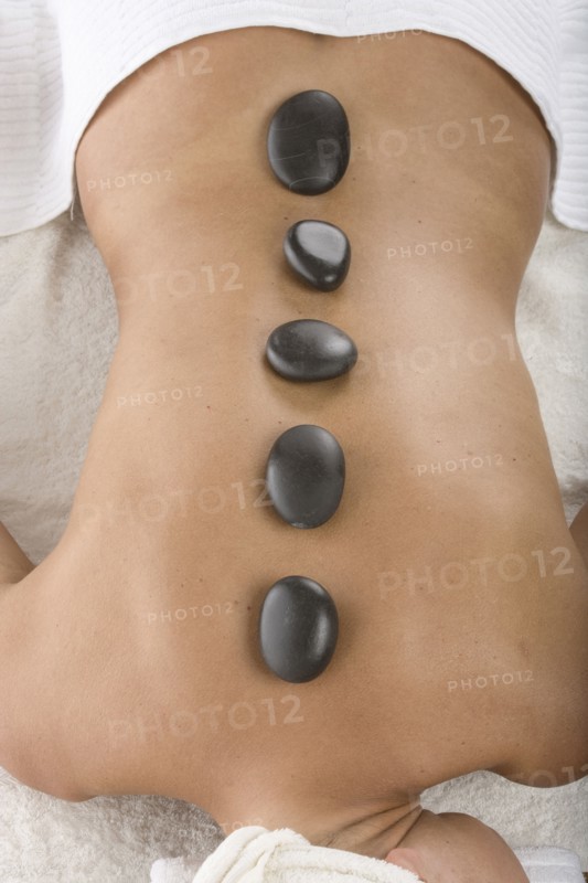 Caucasian woman having hot stone massage