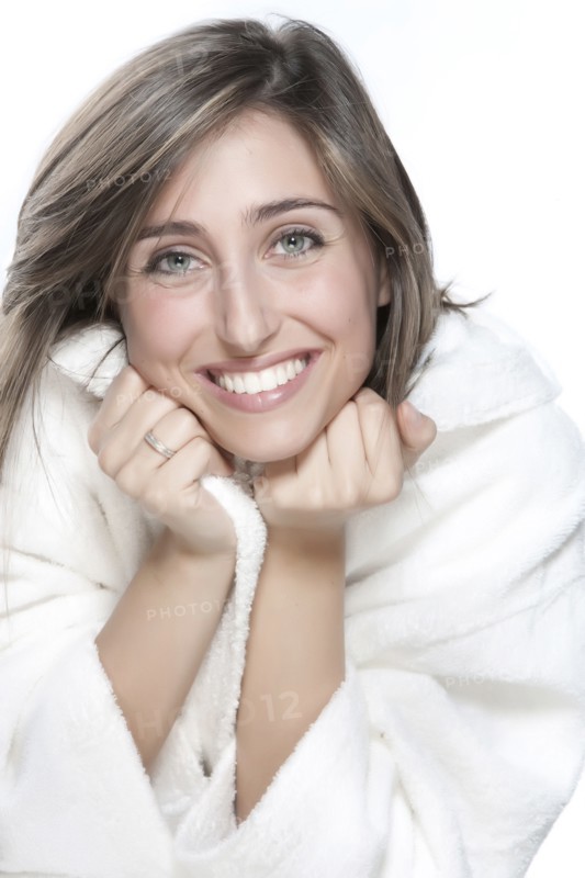 Smiling woman wrapped in bathrobe