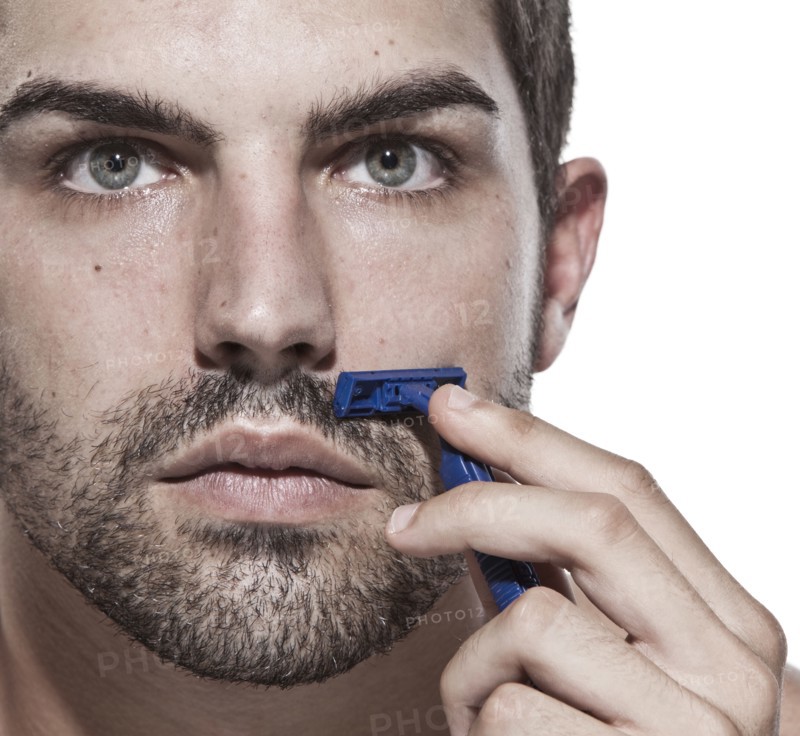 Caucasian man shaving his beard