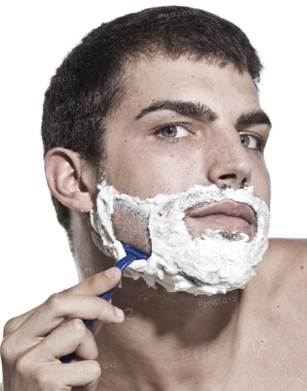 Caucasian man shaving his beard