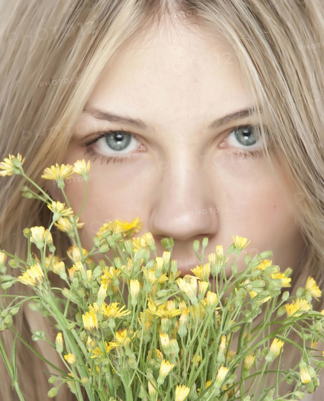 Woman smelling bouquet of flowers