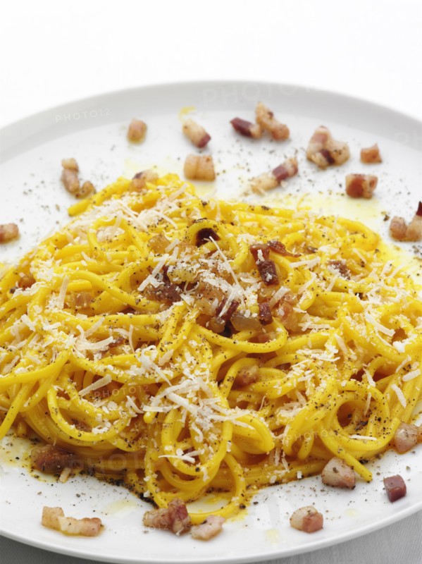 Close up of pasta with bacon bits and cheese
