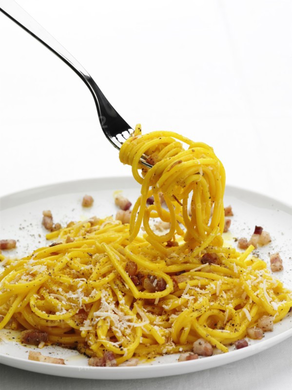 Close up of pasta with bacon bits and cheese