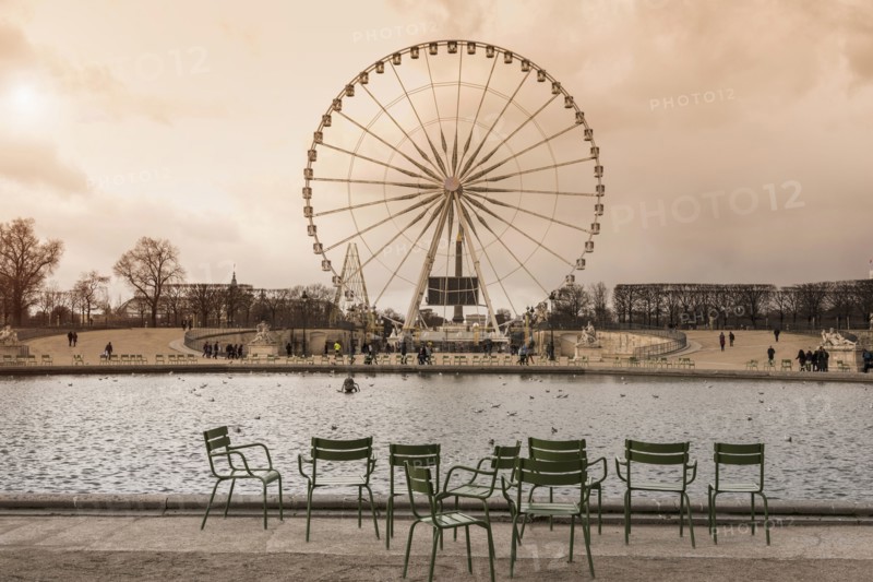 Tourists walking near ferris wheel