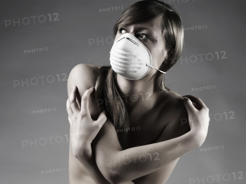 Naked Caucasian woman wearing pollution mask