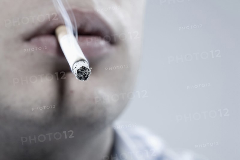 Caucasian man smoking cigarette
