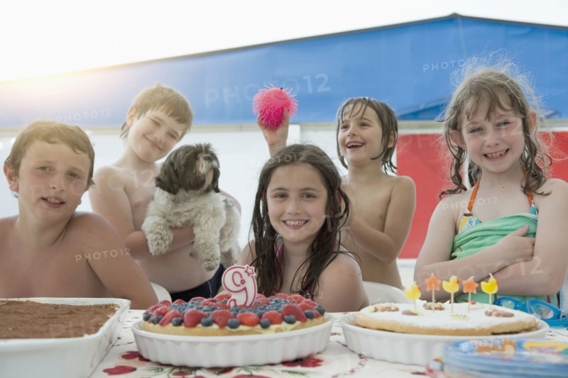 Smiling Caucasian children posing at birthday party