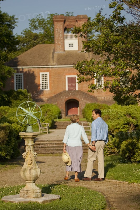 Couple holding hands in garden near house