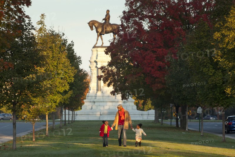 Father and daughters walking in park