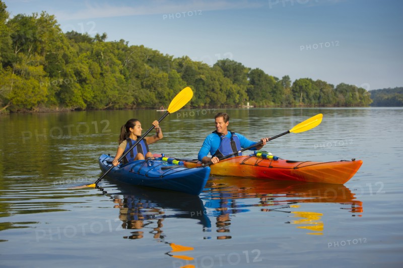 Couple kayaking in river