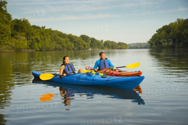 Couple kayaking in river