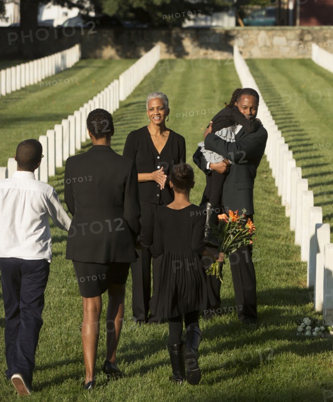 Multi-generation Black family at military cemetery