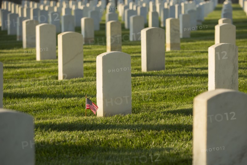 American flag at cemetery gravestone