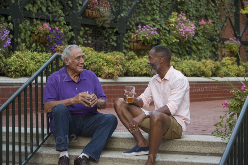 Friends drinking beer in flower garden