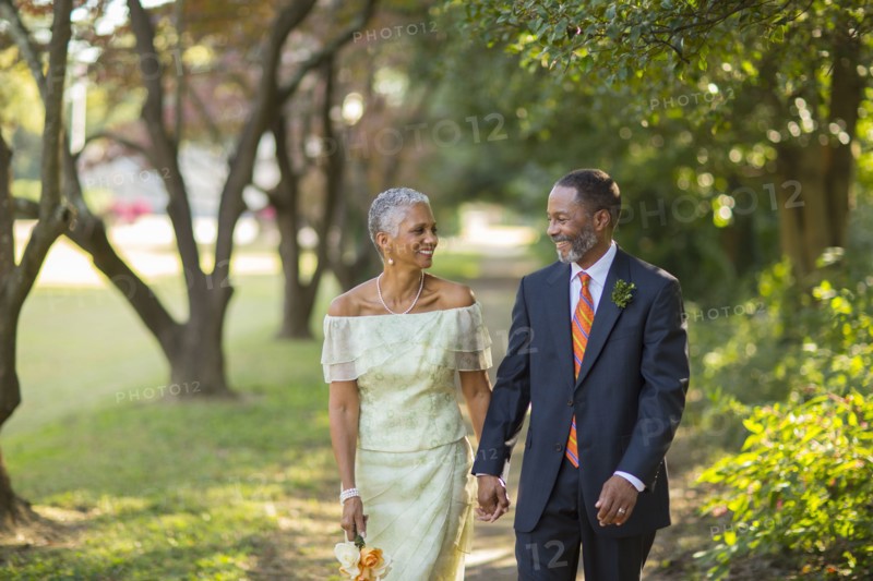 Black couple walking on path in park