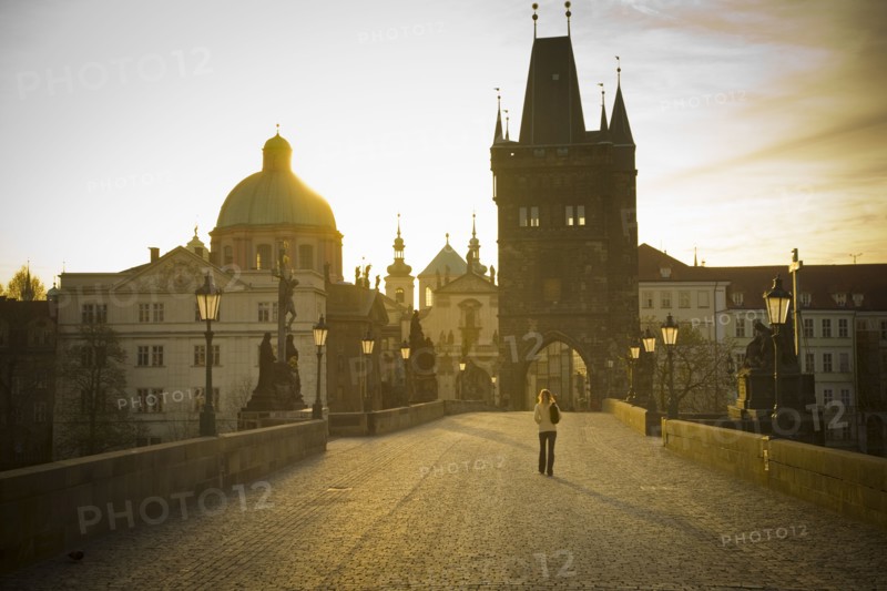 Distant woman standing on bridge in Prague