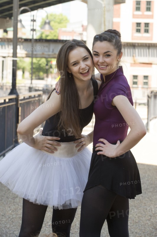 Portrait of smiling Caucasian ballerinas standing outdoors