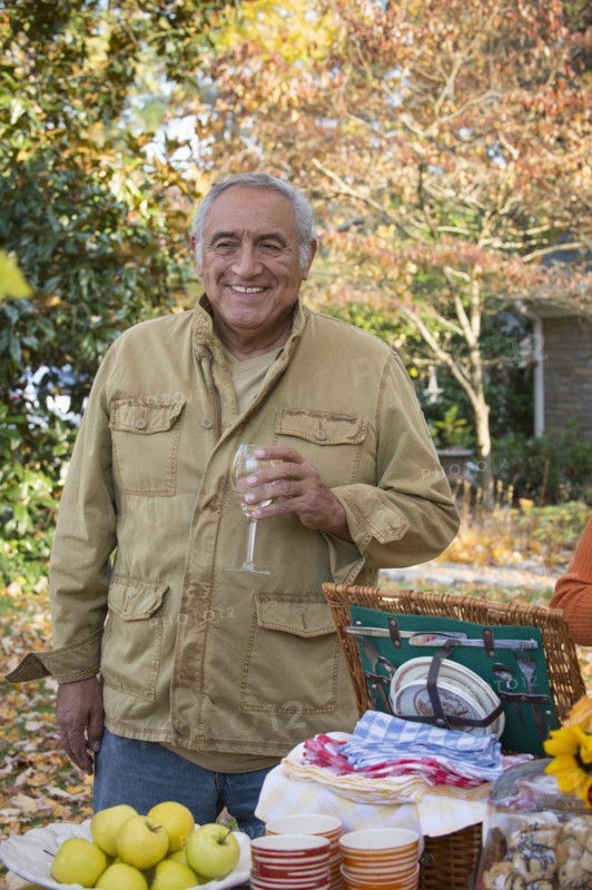 Hispanic man drinking wine outdoors