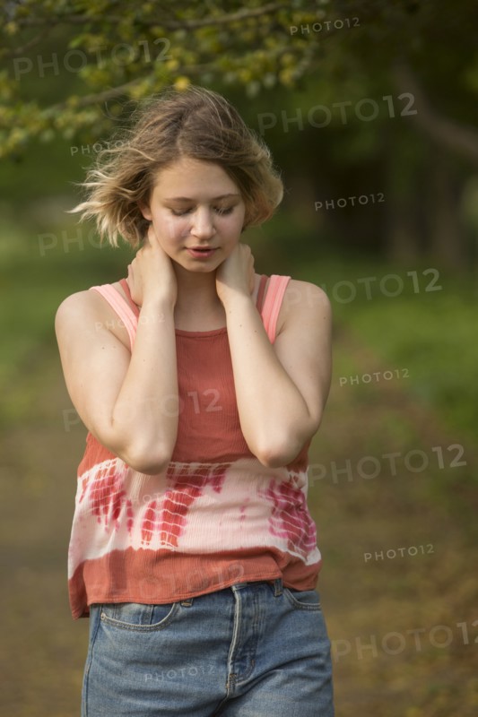 Wind blowing hair of pensive Caucasian teenage girl