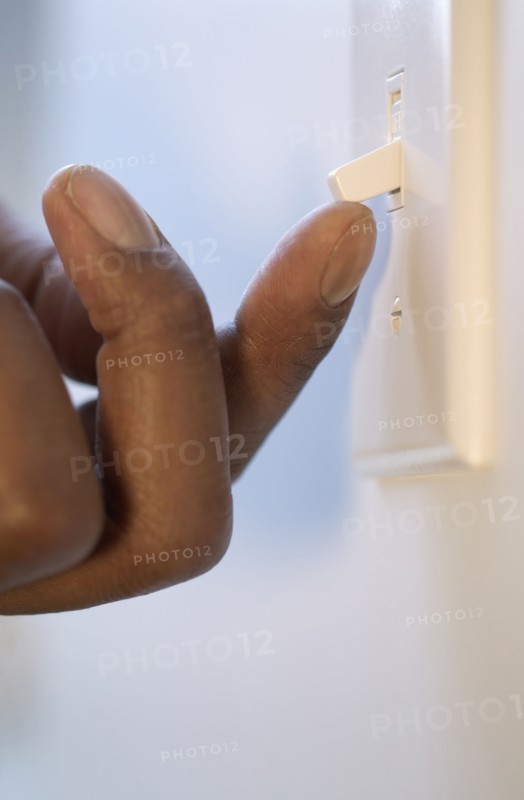 Close up of finger flipping light switch