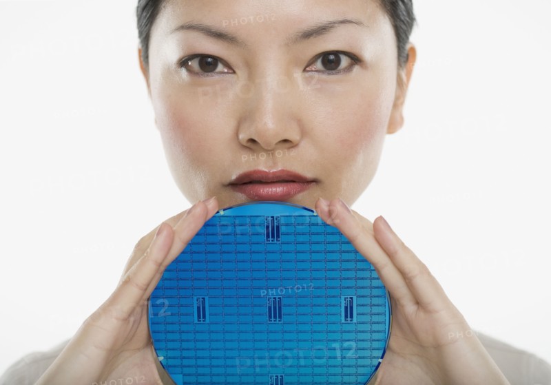 Portrait of woman holding blue disk