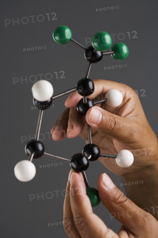 Close up of hands holding model