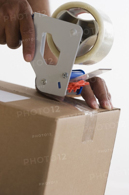 Close up of hands taping up box
