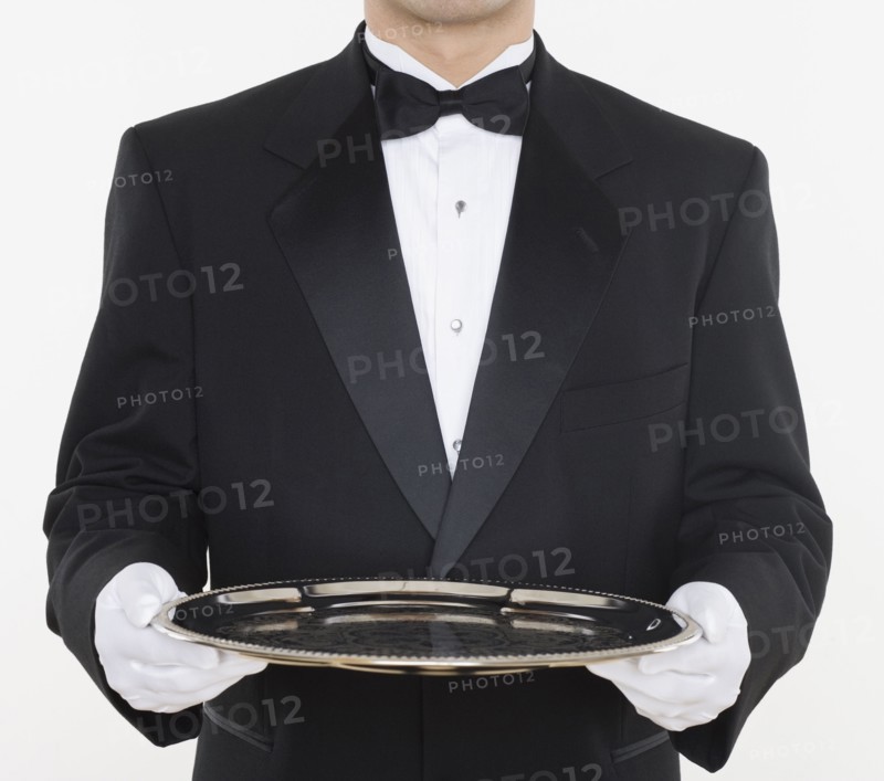 Mid section of male waiter holding tray