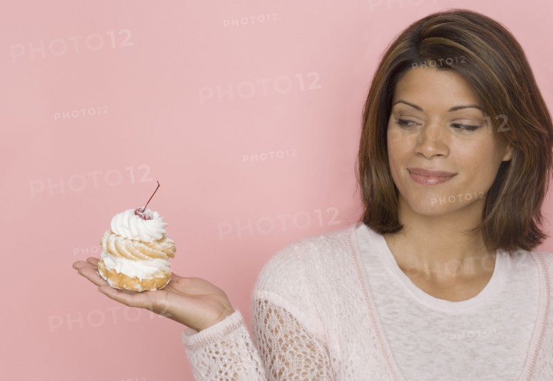 Portrait of woman holding pastry