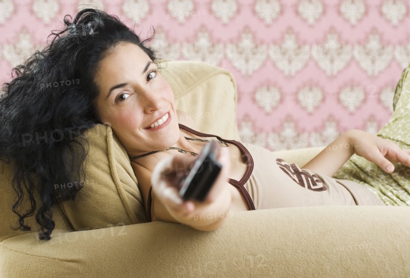 Woman pointing remote at the camera