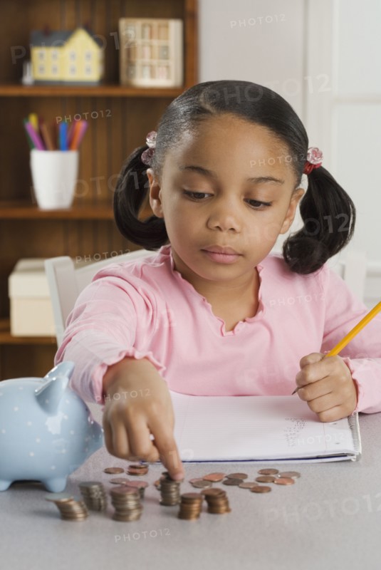 Young girl counting coins