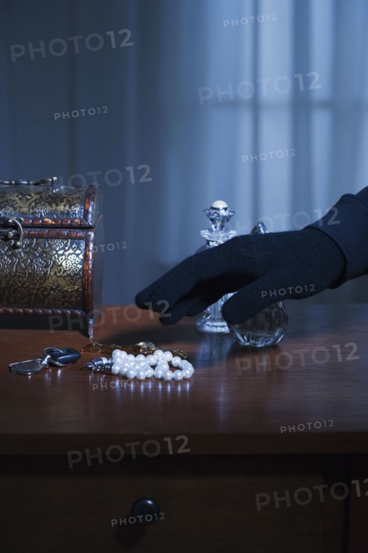 Thief reaching for a string of pearls