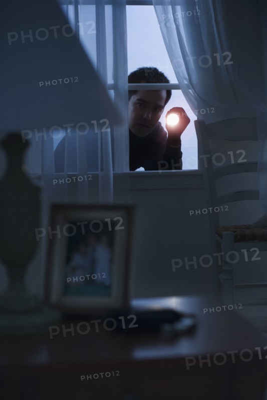 Thief peering in a window