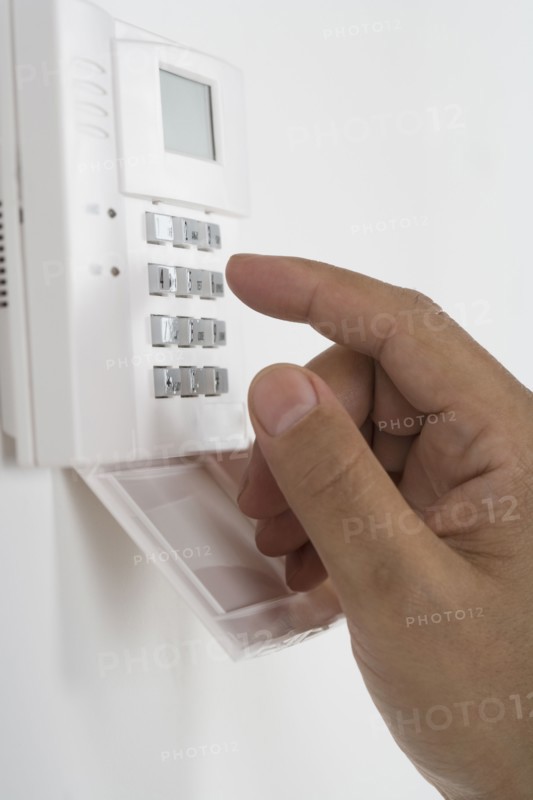 Close of African male hand using keypad