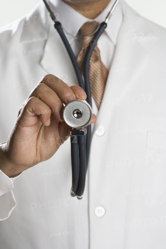 Close up of male doctor's hand holding stethoscope
