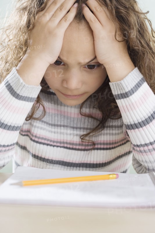 Young girl thinking about homework