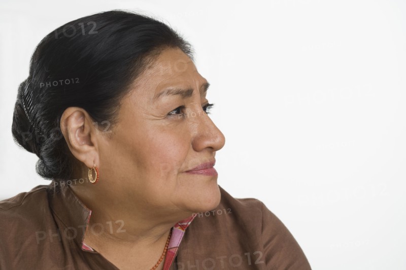 Studio shot of senior Hispanic woman looking to side